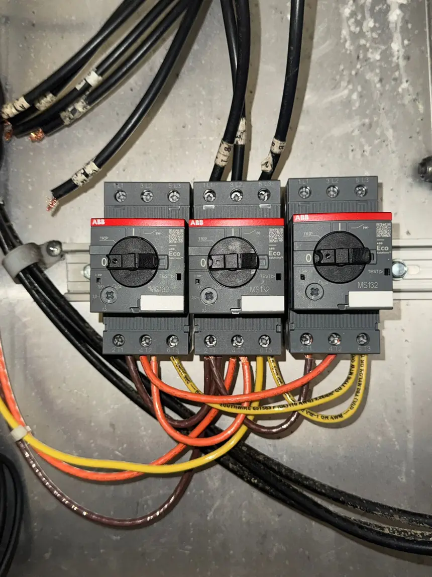 Three ABB MS132 manual motor starters with heavy feeder cabling