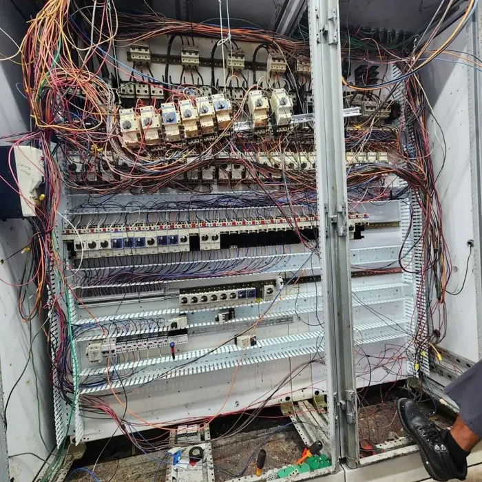 An aged, disorganized control cabinet as found
